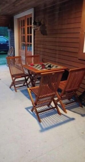 Relax on the porch with a table and four chairs, perfect for enjoying the surroundings.
