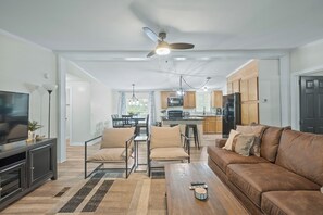 A modern living room with a sofa, chairs, a coffee table, and a TV. - Pet Friendly 3BR Near Lake Norman | Extended Stays (Denver)