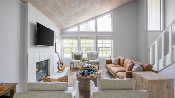 A spacious living room with a fireplace, comfortable seating, and large windows. - Black Oak by Avantstay Modern & Chic Santa Rosa Hideaway With Pool Table, & Fire Pit (Santa Rosa)