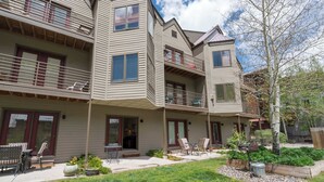 A multi-story residential building with balconies, a patio area with outdoor furniture, and a landscaped garden. - Viking Lodge 117 by Avantstay Ski Home, Near Town Park & Downtown (Telluride)