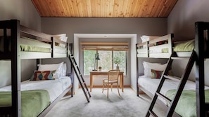 A room with bunk beds, a desk, a chair, and a window. - Skylight by Avantstay Elevated Mountain Home w/ Hot Tub, Billiards, Large Patio (Bend)
