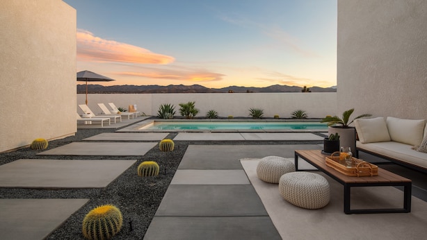 A rooftop patio with a pool, lounge chairs, and a seating area with a coffee table. - Aria by Avantstay Spectacular & Secluded Desert Oasis w/ Pool (Yucca Valley)