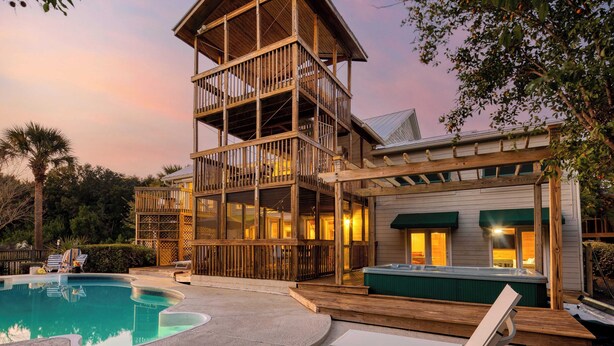 A multi-story wooden building with a pool and hot tub, surrounded by greenery. - Raven by Avantstay Entertainers Dream w/ Pool, Hot Tub, Game Room! 9 Brs! (Sullivan's Island)
