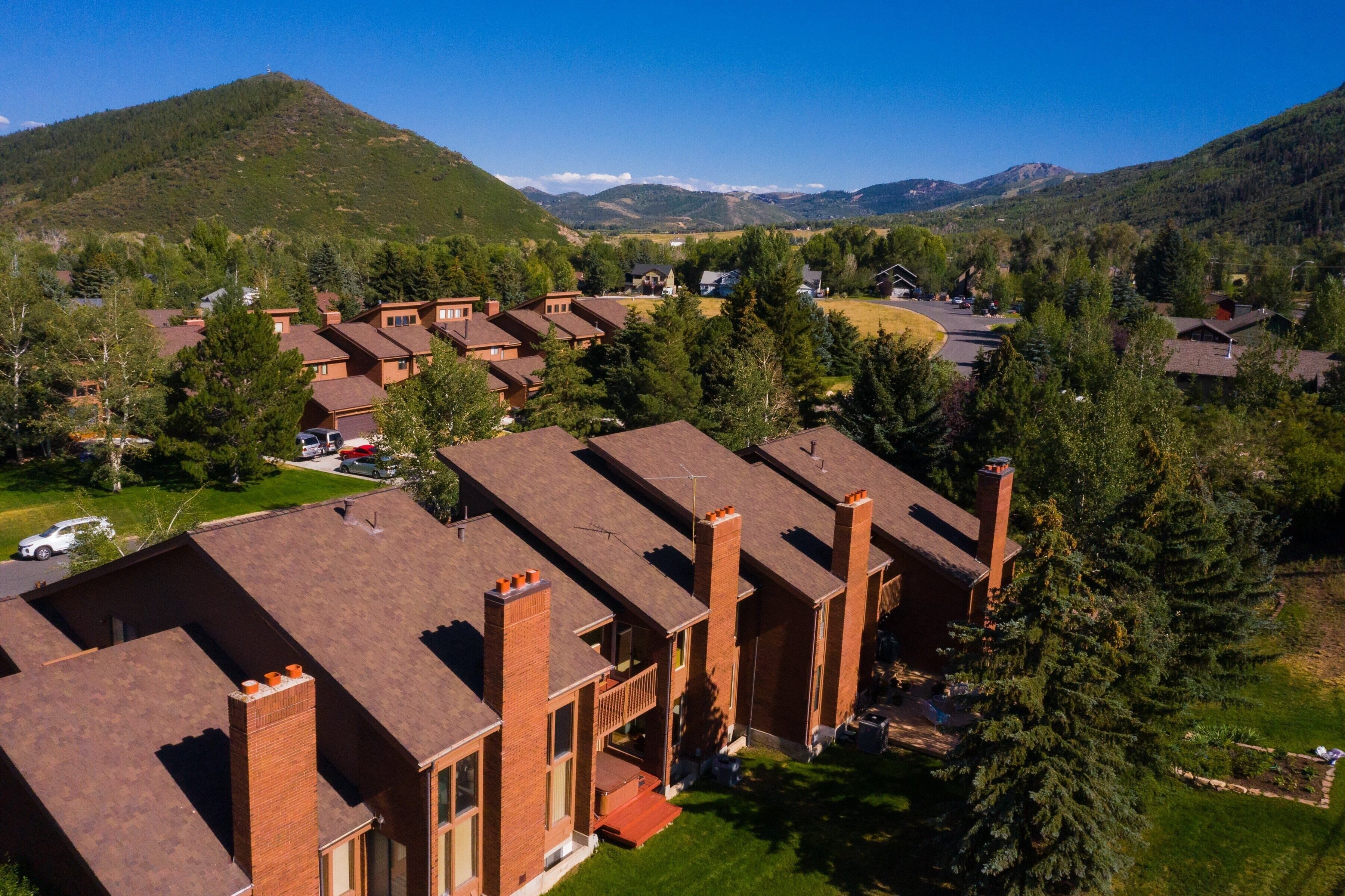 A residential area with multiple brick houses, each featuring a chimney and a small porch.