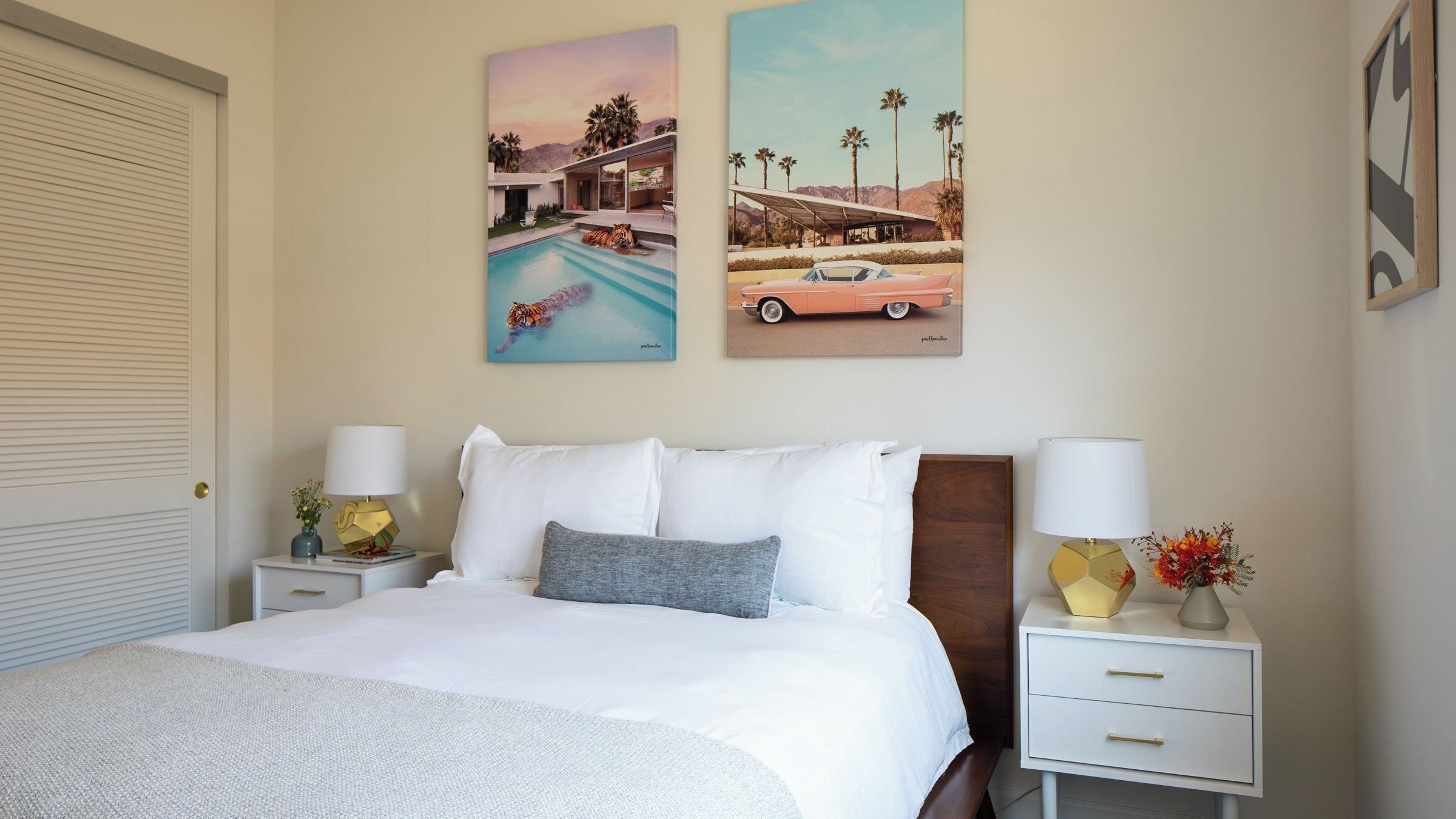 A bedroom with a bed, two nightstands, a dresser, and two wall art pieces depicting a pool and a car.