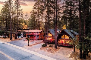 A lodge with a rustic exterior, multiple rooms, and a visible parking area.
