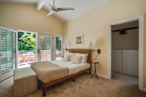 A bedroom with a bed, a bedside table, a ceiling fan, a window with blinds, and a closet.