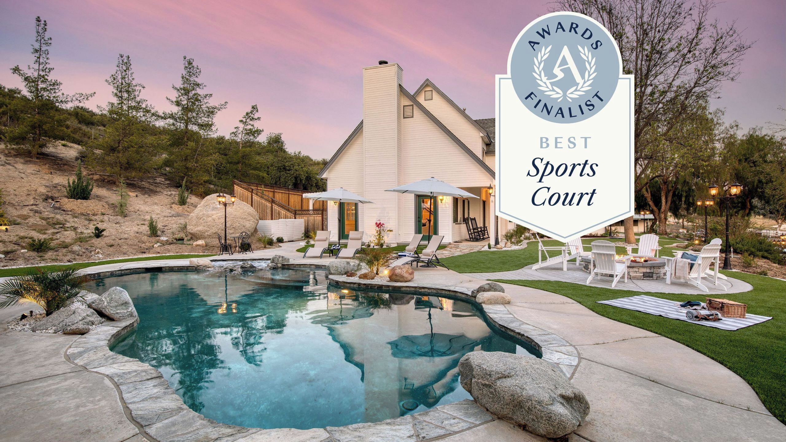 A house with a swimming pool, outdoor seating, and a sign indicating it is a finalist for Best Sports Court.