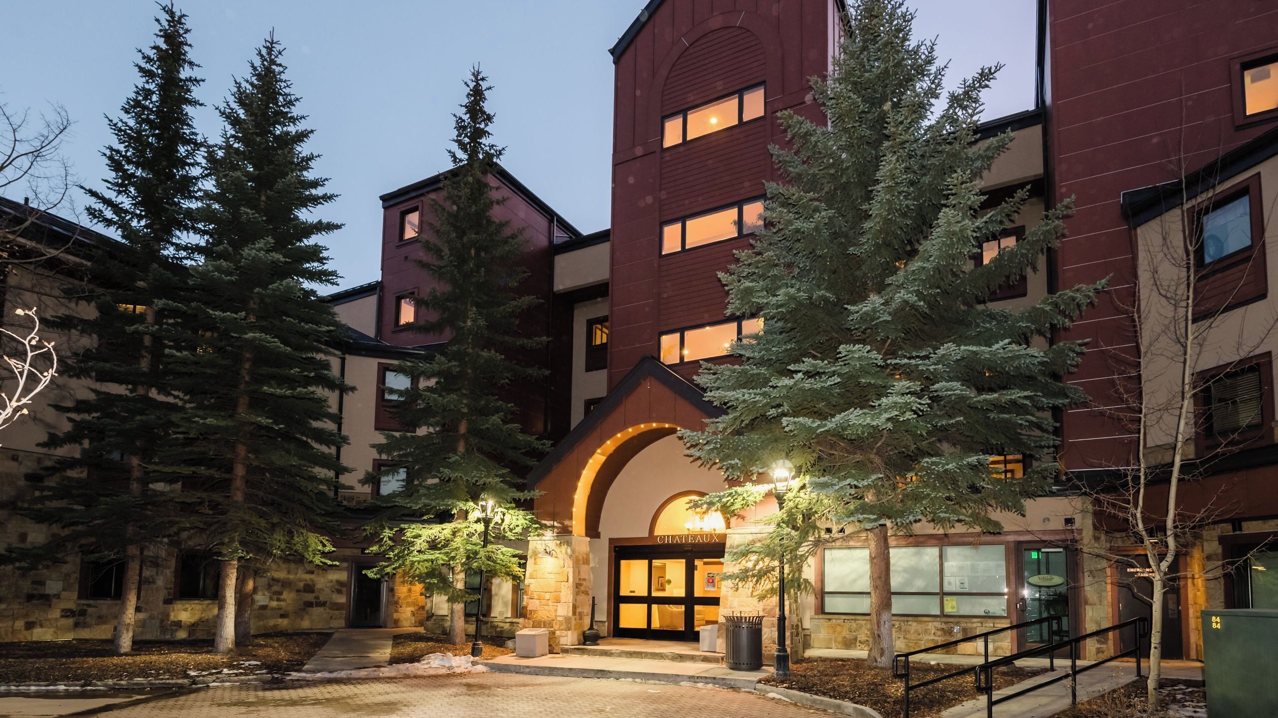 A multi-story building with a central entrance, stone pillars, and a sign reading 'CHATEAUX.'