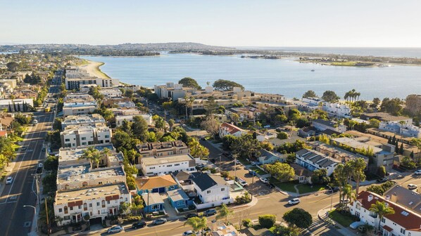 An aerial view of a coastal residential area with buildings, roads, and a large body of water. - Indigo By Avantstay Sleek & Charming Home 2 Blks From Bay w/ Hot Tub! (San Diego)