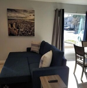 Relax in this stylish living room with a sofa, coffee table, and city view.