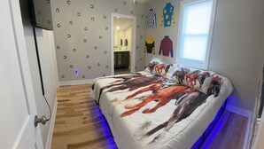 A bedroom with a bed, wooden flooring, a ceiling fan, and a window. - Bright, Cheery Home steps from Shops & Nightlife! (Louisville)
