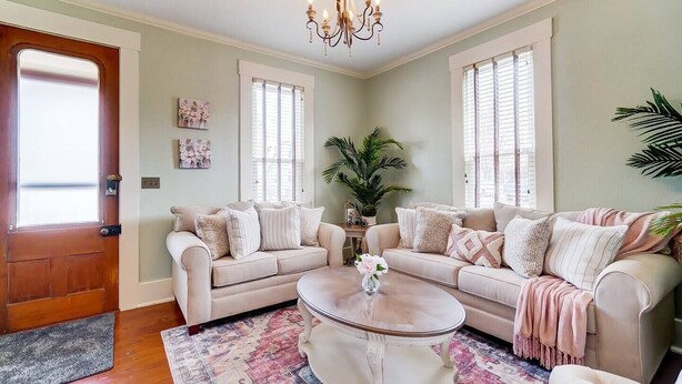 A living room with two sofas, a coffee table, and a chandelier. - Walk to Restaurants & Shops of Downtown Miamisburg (Miamisburg)