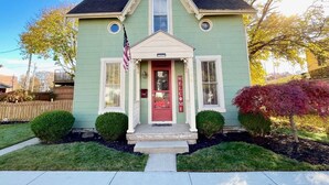 A two-story house with a red front door, a welcome sign, and an American flag. - Walk to Restaurants & Shops of Downtown Miamisburg (Miamisburg)