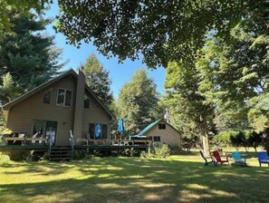 Relax on the covered porch with comfortable seating and take in the serene surroundings.