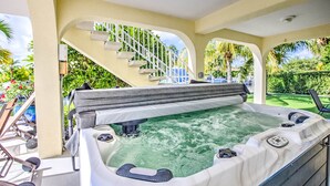A hot tub with a staircase leading to a covered area, surrounded by greenery. - Private Pool, Hot Tub, Boat Dock, Putting Green (Marathon)