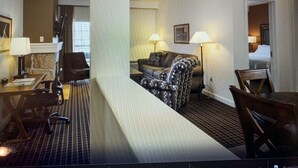 A hotel room with a living area, a dining table, and a separate bedroom. - Golf resort for Labor Weekend (Klamath Falls)