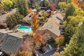 Residents enjoy a central pool surrounded by trees in this residential neighborhood.