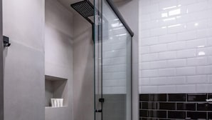 A modern bathroom with a glass-enclosed shower, a toilet, and a tiled backsplash. - 3 Minutes From Copacabana Beach Df115 (Rio de Janeiro)