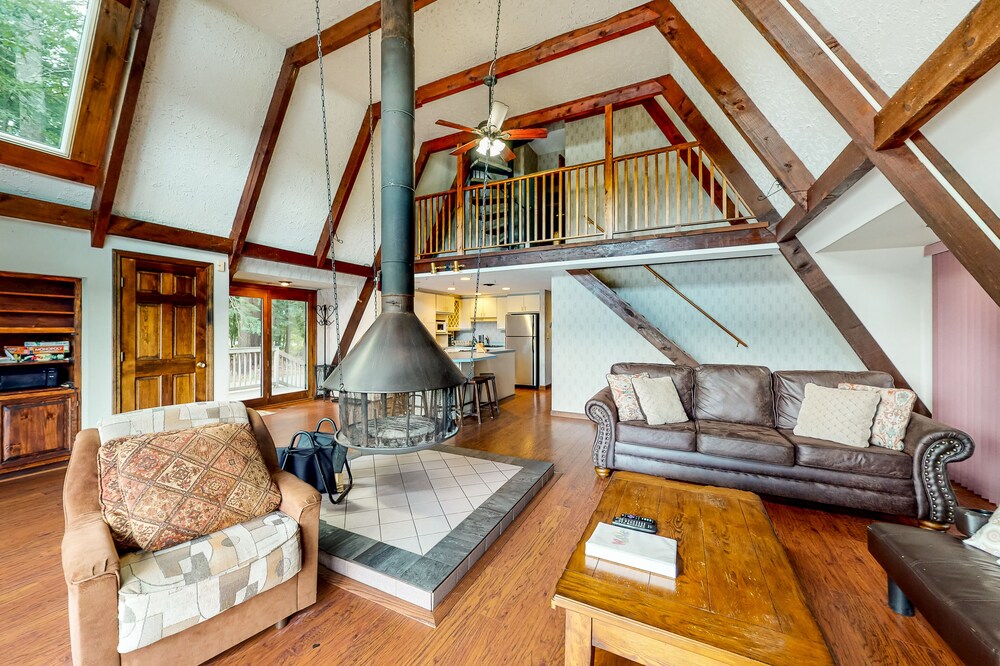 Waterfront home with wraparound deck, floating fireplace, deck, & firepit