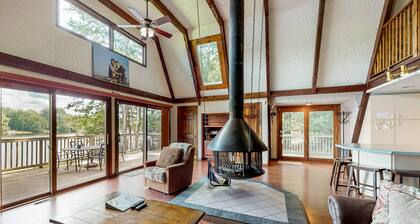 Waterfront home with wraparound deck, floating fireplace, deck, & firepit