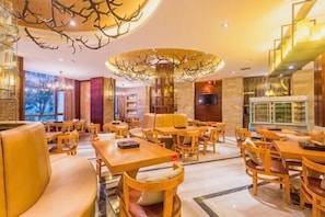 A restaurant with wooden furniture, a chandelier, and a TV. - Bosai Hotel (Chongqing)