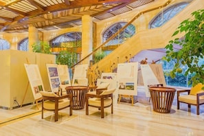 A spacious atrium with a high ceiling, large windows, and a central staircase. - Bosai Hotel (Chongqing)