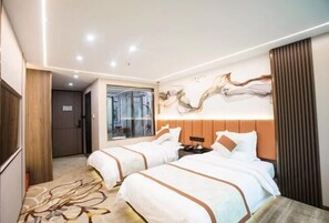 Two beds with white bedding and brown accents, a large window, and a striking abstract painting adorn this stylish room.