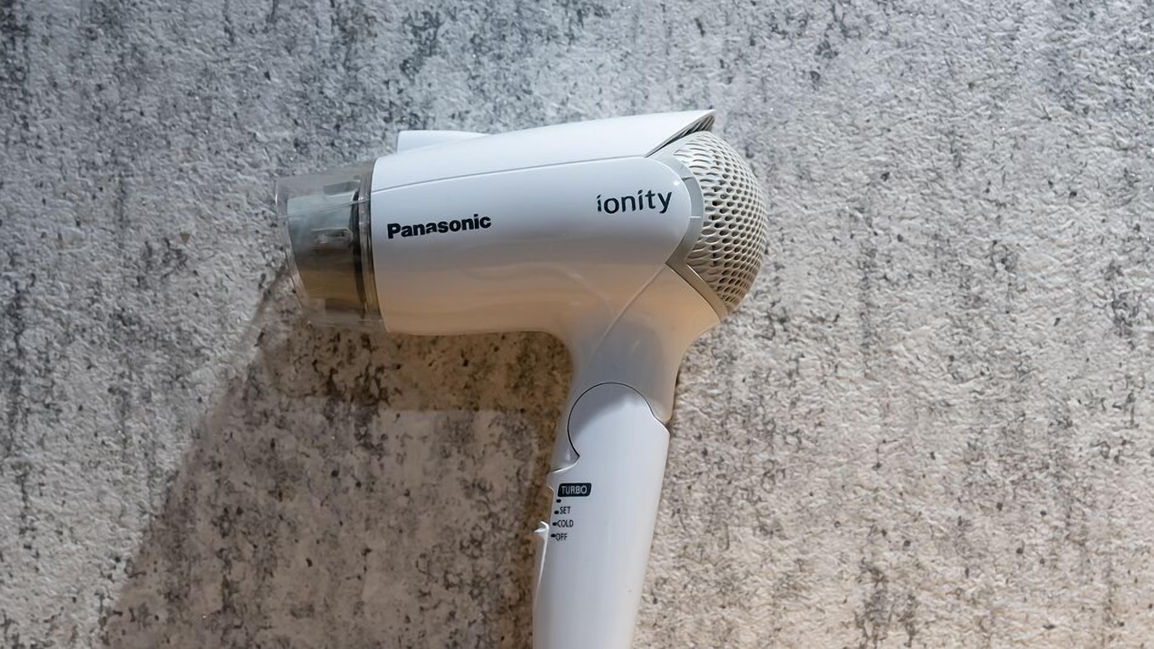 A Panasonic Ionity hair dryer on a textured surface.