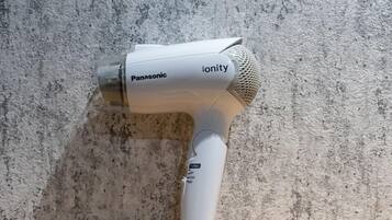 A Panasonic Ionity hair dryer on a textured surface.