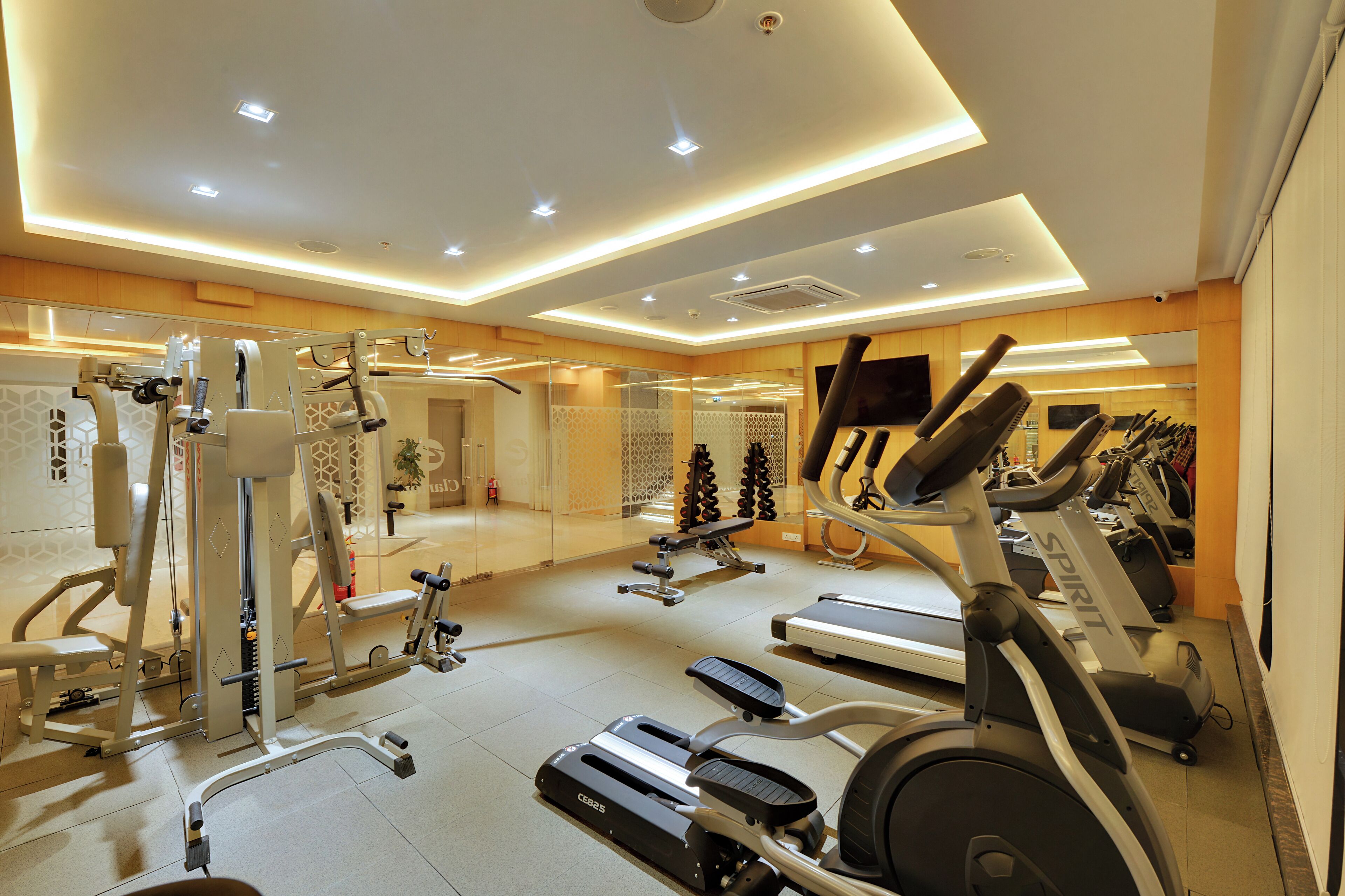 A modern gym with various exercise equipment, including treadmills and weight machines.