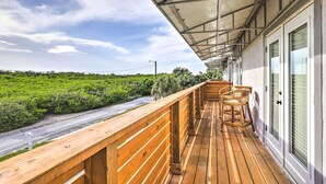 A wooden deck with a glass door and window, overlooking a road and lush greenery. - Tampa House w/ Patio, Near Downtown & Beaches! (Tampa)