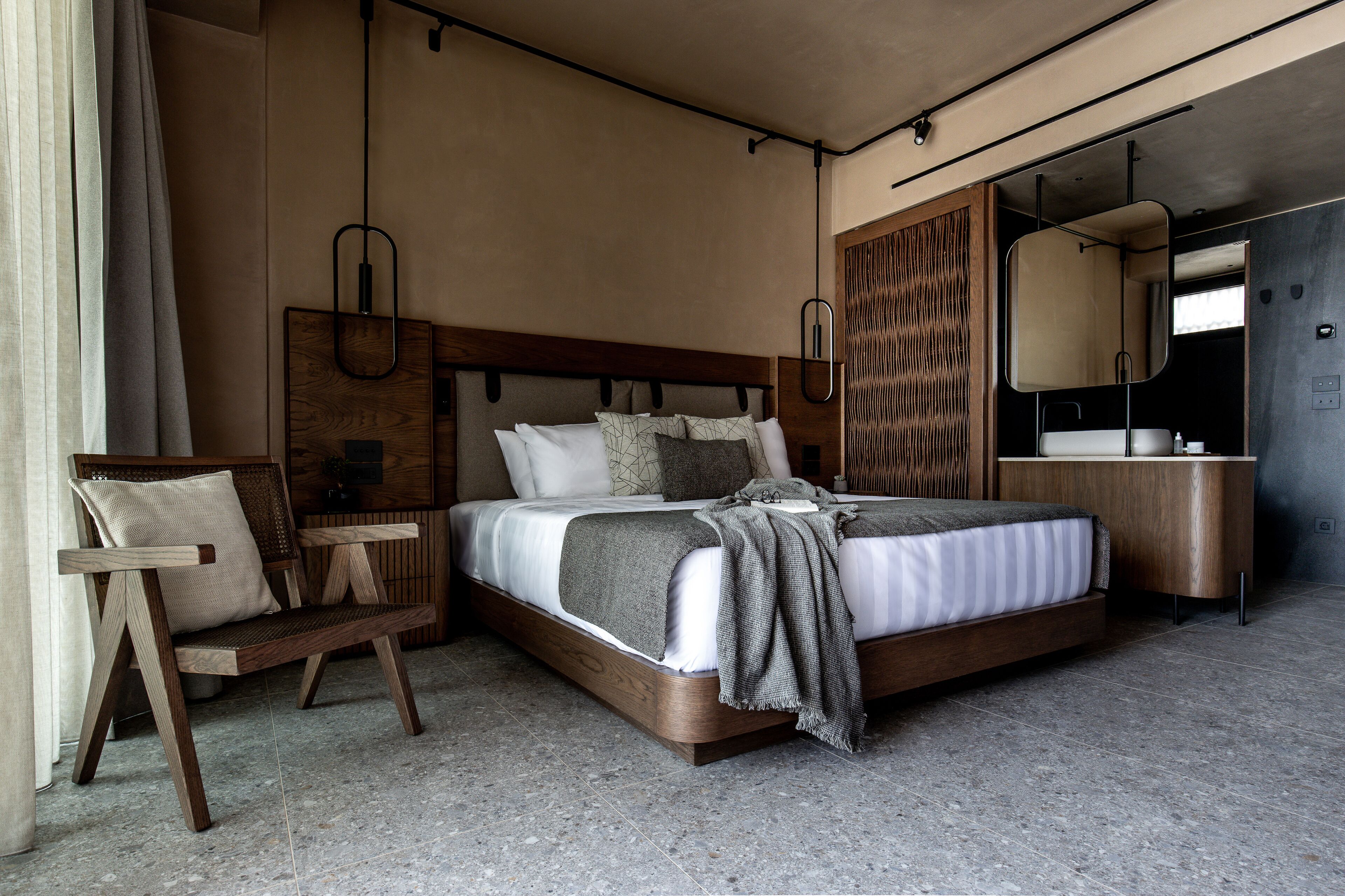 A modern bedroom with a wooden bed, a bedside table, a chair, and a built-in wardrobe.