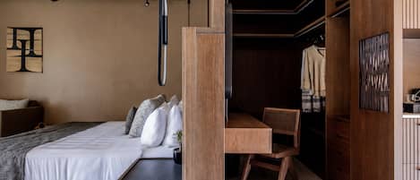 A modern bedroom with a wooden bed, a desk, and a wardrobe.