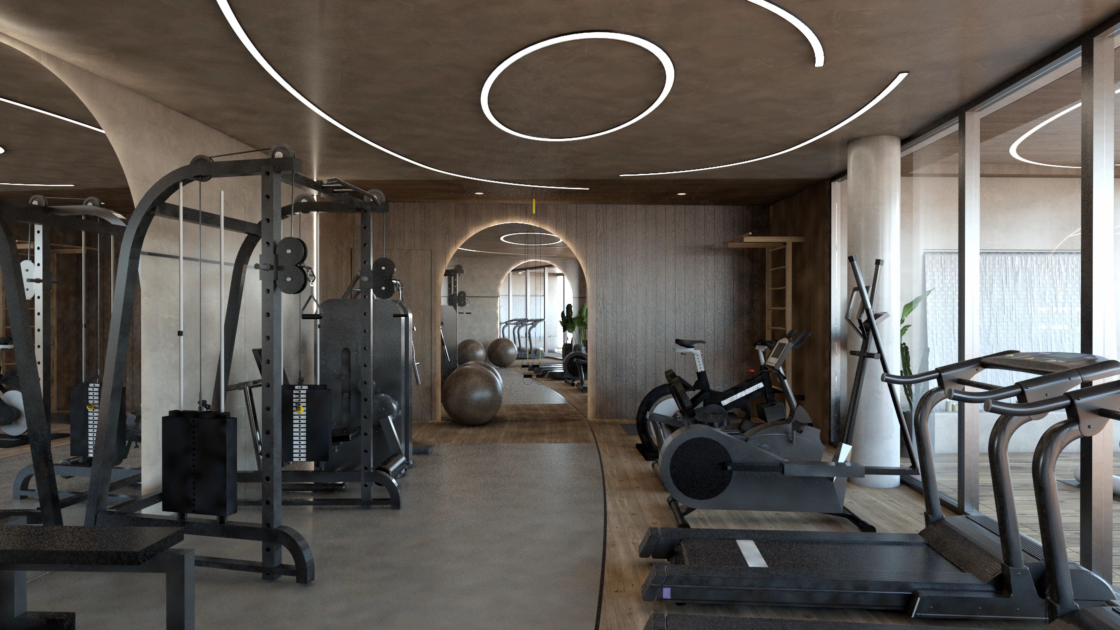Un gimnasio moderno con diversos equipos de ejercicio, incluyendo cintas de correr y máquinas de pesas, y un diseño amplio con iluminación natural.
