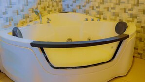 A large, white, freestanding bathtub with a black rim and a single faucet. - Welkom to Myplace (Kigali)