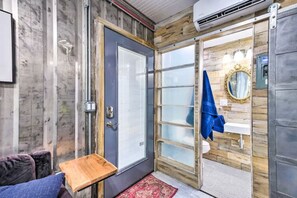 Cozy retreat with a wooden door, small table, and modern sink.