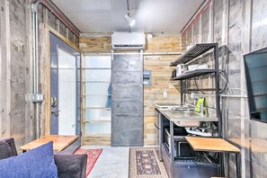 Enjoy a functional kitchen with stove, sink, and casual seating area.