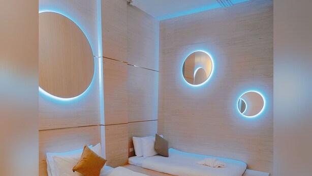 A modern room with two beds, wooden paneling, and circular light fixtures. - Icon Hotel Hatyai (Hat Yai)