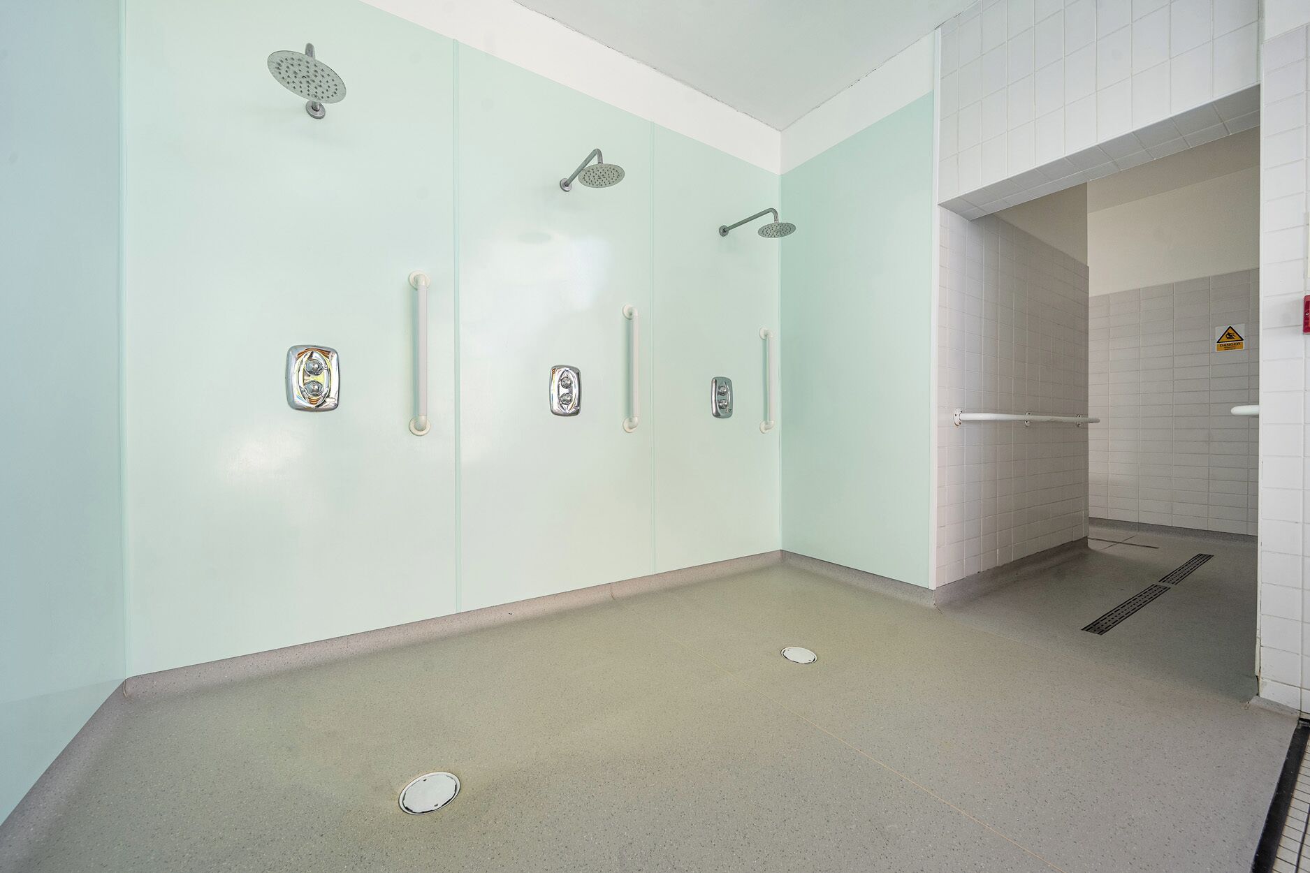 A bathroom with a shower, a toilet, and a sink.