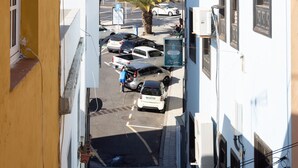A narrow street with parked cars and buildings on both sides. - Fantastic location. San Andrés-Las Teresitas (San Andres)