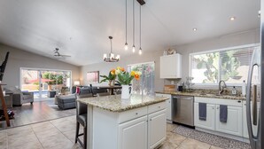 A spacious kitchen with a central island, white cabinetry, and a large window with blinds. - Gated! 3/2 Pool, Bbq, Fire-Table! License #2034087 (Scottsdale)