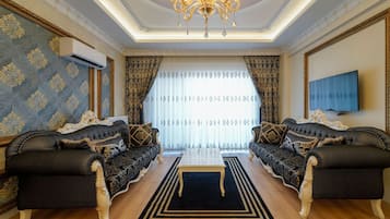 Premium Suite | Living area | 160-inch LED TV with satellite channels, Netflix, first-run films