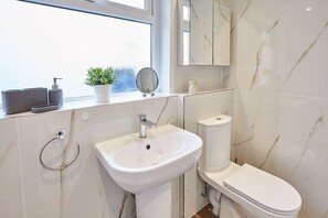 Bathtub, hair dryer, towels, soap