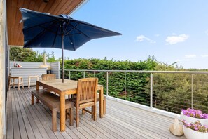 Enjoy al fresco dining on the deck with a beautiful view of the lush surroundings.