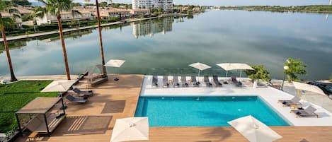 Outdoor pool, open 10:00 AM to 7:00 PM, pool umbrellas, pool loungers