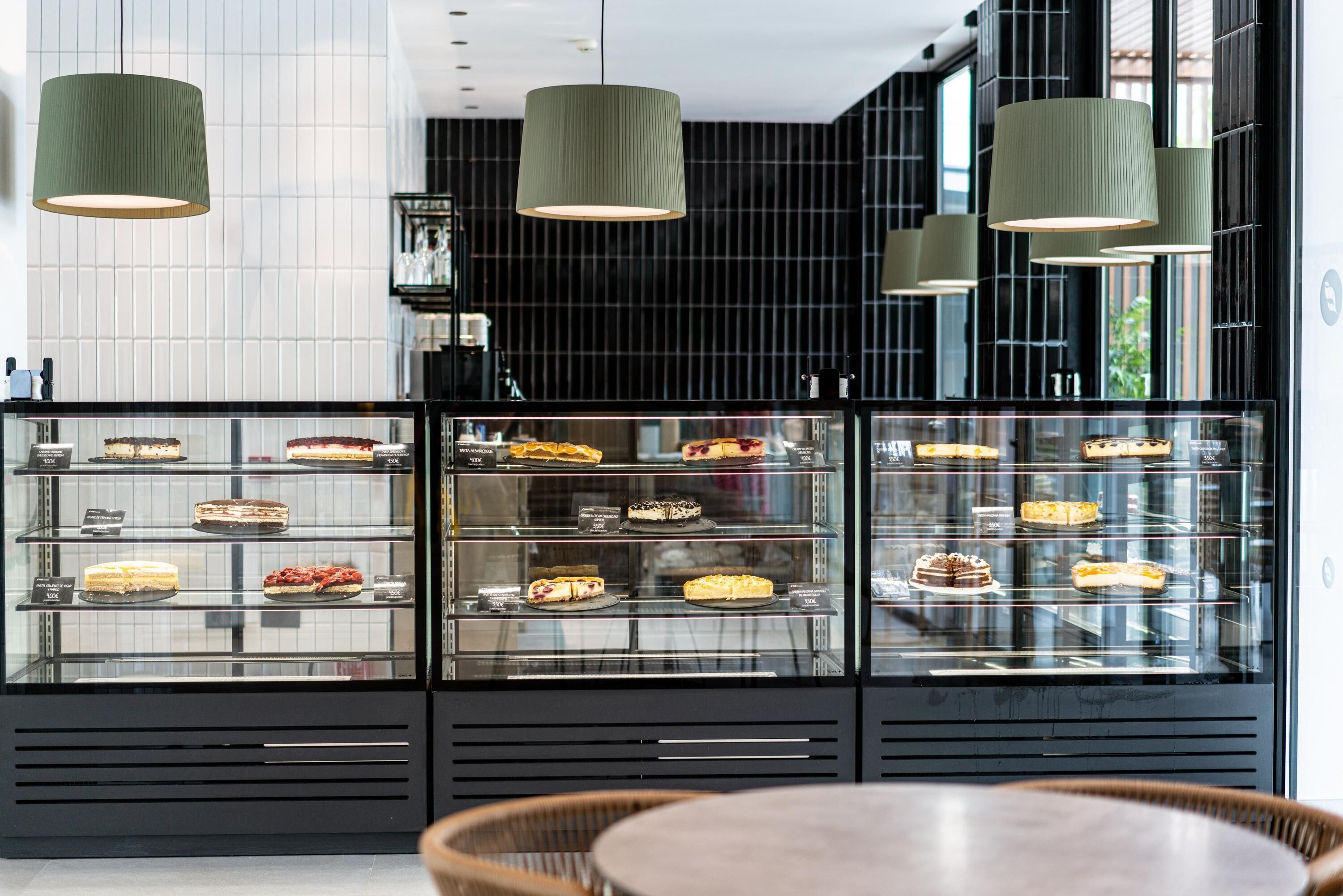 A bakery display case with various cakes and pastries.