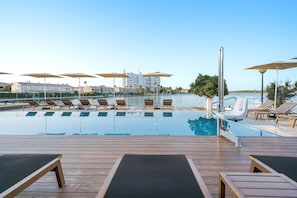 Outdoor pool, open 10:00 AM to 7:00 PM, pool umbrellas, pool loungers