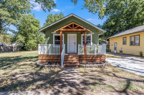 A small, single-story house with a front porch and a mailbox.