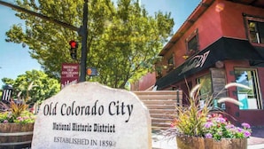 A stone sign for Old Colorado City National Historic District with a wooden planter and flowers nearby. - Sheridan Wildflower! Downtown Family Fun w/Firepit (Colorado Springs)
